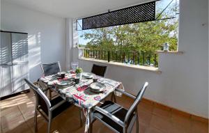 a dining room with a table and chairs and a window at Gorgeous Apartment In Sucina With Swimming Pool in Sucina