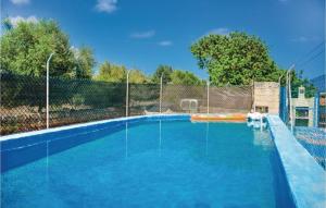 una piscina de agua azul y una valla en Nice Home In Porto Cristo With House A Mountain View, en Porto Cristo