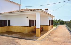 a white and yellow house with a driveway at 3 Bedroom Awesome Home In Porto Cristo in Porto Cristo