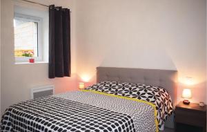 a bedroom with a black and white bed and a window at Pet Friendly Home In Saint Alban in Saint-Alban