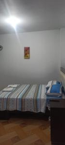 een slaapkamer met een bed met een foto aan de muur bij La Petite Maison in Nazca