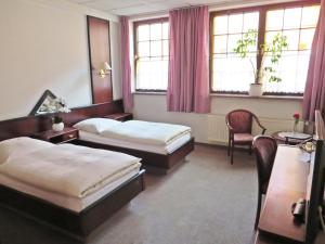 Ein Bett oder Betten in einem Zimmer der Unterkunft Hotel Roseneck