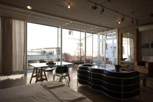 a bedroom with a bed and a table and chairs at City Centre Studios in Limassol