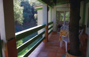 a porch of a house with a table and chairs at Nice Apartment In Sagone With Kitchen in Sagone