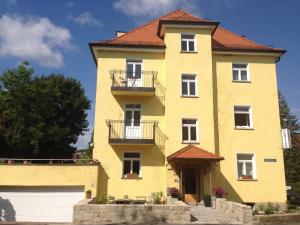 a yellow building with a red roof at Sanderau NA29 in Würzburg
