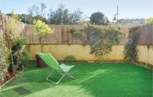 a green lawn chair sitting in a yard at 2 Bedroom Stunning Apartment In Llanes in Llanes