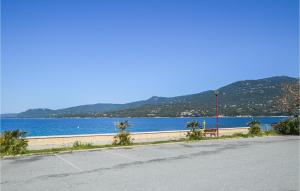an empty road next to a body of water at 1 Bedroom Lovely Apartment In Propriano in Propriano