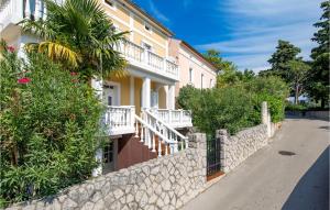 a building with a stone wall next to a street at Beautiful Apartment In Omisalj With Wifi in Omišalj