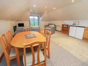 a kitchen and a dining room with a table and a living room at Bruce in Pitlochry