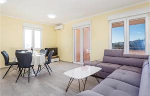 a living room with a couch and a table and chairs at 2 Bedroom Beautiful Apartment In Cavle in Čavle