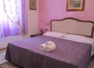 Posteľ alebo postele v izbe v ubytovaní B&B Regina Margherita