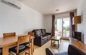 a living room with a dining table and a couch at 2 Bedroom Cozy Apartment In Roldn in Roldán