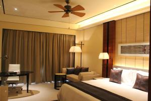 a hotel room with a bed and a desk at Crowne Plaza Sanya City Center, an IHG Hotel in Sanya
