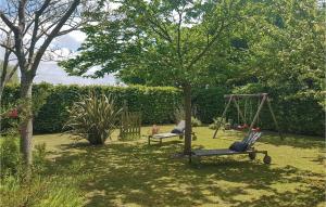a yard with two swings and a tree at Gorgeous Home In Mont-Dol With Wifi in Mont-Dol