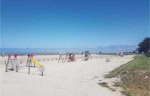 an empty playground on a sandy beach with the ocean at Gorgeous Home In Mont-Dol With Wifi in Mont-Dol +11 photos