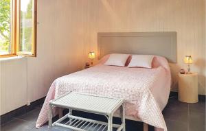 a bedroom with a bed with a white blanket and a table at Gorgeous Home In Mont-Dol With Wifi in Mont-Dol