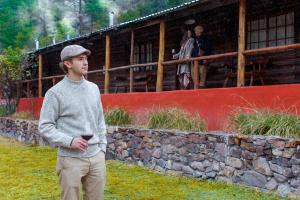 a young man standing in front of a building at Bosques in Creel +17 photos