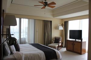 a hotel room with a bed and a flat screen tv at Crowne Plaza Sanya City Center, an IHG Hotel in Sanya