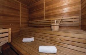 a wooden sauna with two white towels in it at Awesome Home In Skradin With Sauna in Skradin