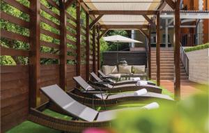 a group of lounge chairs on a patio at Awesome Home In Skradin With Sauna in Skradin +50 photos