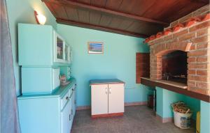 a kitchen with a stove and a brick oven at 1 Bedroom Beautiful Apartment In Liznjan in Ližnjan
