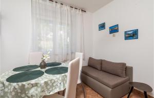 a dining room with a table and a chair at Beautiful Apartment In Jablanac With Wifi in Jablanac