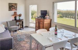 a living room with a couch and a table with wine glasses at Beautiful Home In Plouarzel With Indoor Swimming Pool in Rubian