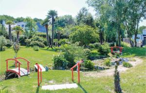 a garden with red rails in the grass at Awesome Home In Bénodet With Wifi in Bénodet +17 photos