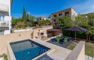 a swimming pool in the backyard of a house at Nice Apartment In Dramalj With Wifi in Dramalj