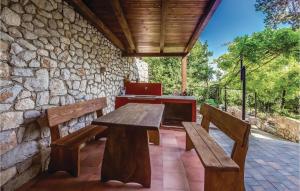a wooden table and two benches on a patio at Nice Home In Bribir With Wifi in Bribir