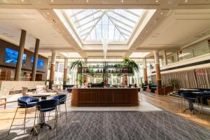 a lobby with a reception desk and chairs at Novotel Wollongong Northbeach in Wollongong