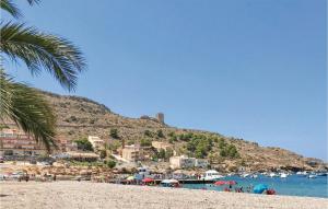a beach with a bunch of buildings and a mountain at Amazing Apartment In La Azohía in La Azohía