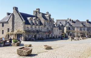 a cobblestone street in front of a large building at 2 Bedroom Nice Home In Plonevez Porzay in Plonévez-Porzay