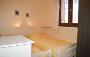 a small bedroom with a bed and a window at Three-Bedroom Holiday Home In Calcatoggio in Calcatoggio