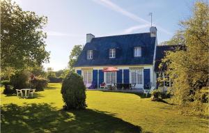 a large blue and white house with a yard at Stunning Home In Concarneau With Wifi in Concarneau