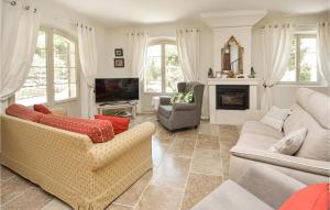 a living room with two couches and a tv at Beautiful Home In Eygalires With Kitchen in Eygalières