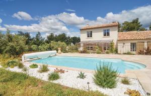 a swimming pool in front of a house at Beautiful Home In Eygalires With Kitchen in Eygalières