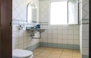 a bathroom with a sink and a toilet at Villas Del Mar in Puerto Calero