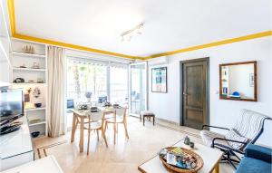 a living room with a table and chairs at Stunning Apartment In La Herradura-almuecar With Kitchen in La Herradura