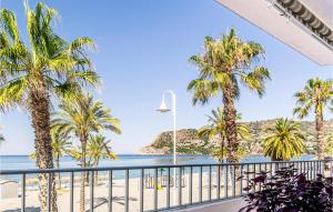 a view of the beach from the balcony of a resort at Stunning Apartment In La Herradura-almuecar With Kitchen in La Herradura
