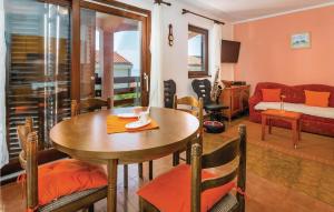 a living room with a table and a couch at 1 Bedroom Pet Friendly Apartment In Labin-ravni in Ravni