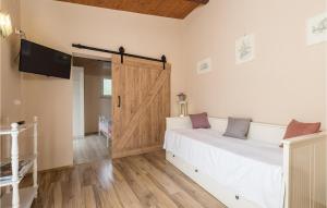 a bedroom with a bed and a sliding door at 1 Bedroom Lovely Home In Lovran in Lovran