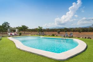 a swimming pool in the middle of a yard at Finca Can Mel in Búger