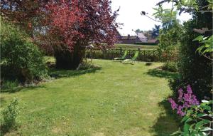 a garden with a fence and flowers in the grass at Lovely Home In Frise With Wifi in Frise