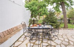 a black table with chairs and a table with fruit on it at Beautiful Home In Zahara De La Sierra in Zahara de la Sierra