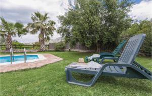 a group of lawn chairs sitting next to a swimming pool at Beautiful Home In Zahara De La Sierra in Zahara de la Sierra