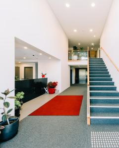 a staircase with a red carpet in a building at Voyager Motel in Wallgrove