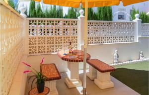 a patio with a table and chairs and an umbrella at Stunning Home In Quesada-Rojales in Rojales