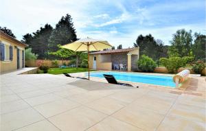 a patio with an umbrella and a swimming pool at Gorgeous Home In Mornas in Mornas +31 photos
