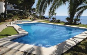 a large swimming pool with the ocean in the background at Awesome Home In Altea With 2 Bedrooms in Altea